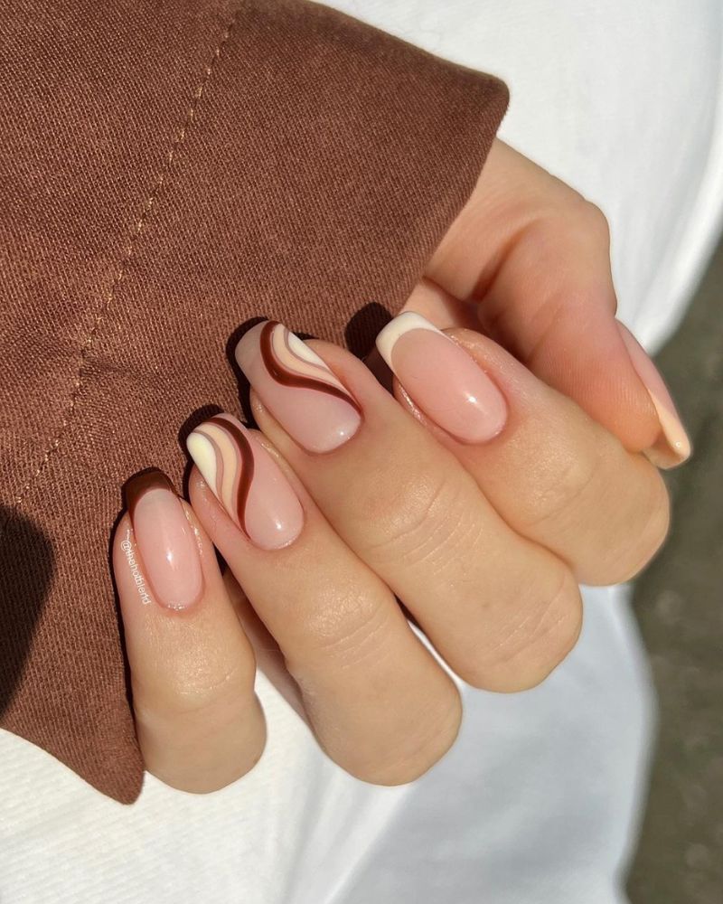 cute fall nails with French designs and swirly nail art, in brown shades