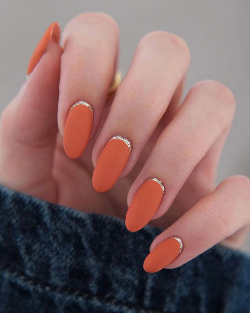 matte orange fall nails with an elegant look