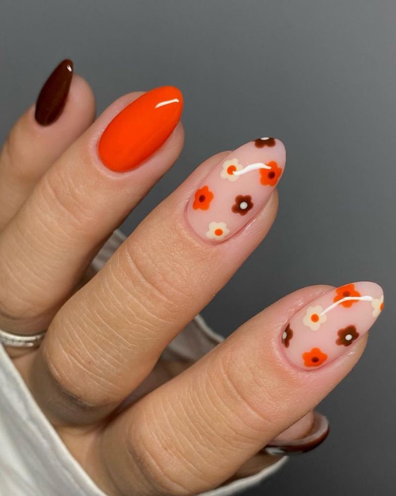 orange fall nails and brown fall nails with floral nail art