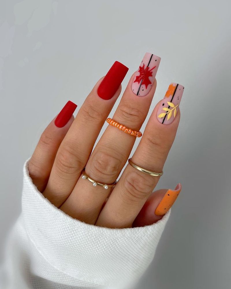 fall manicure with matte finish in red and orange colors