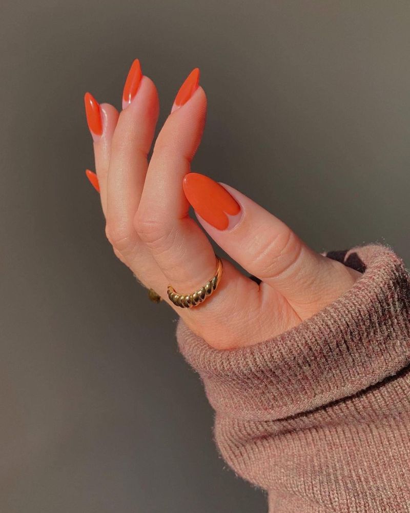 burnt orange fall nails with an elegant design on long almond shape
