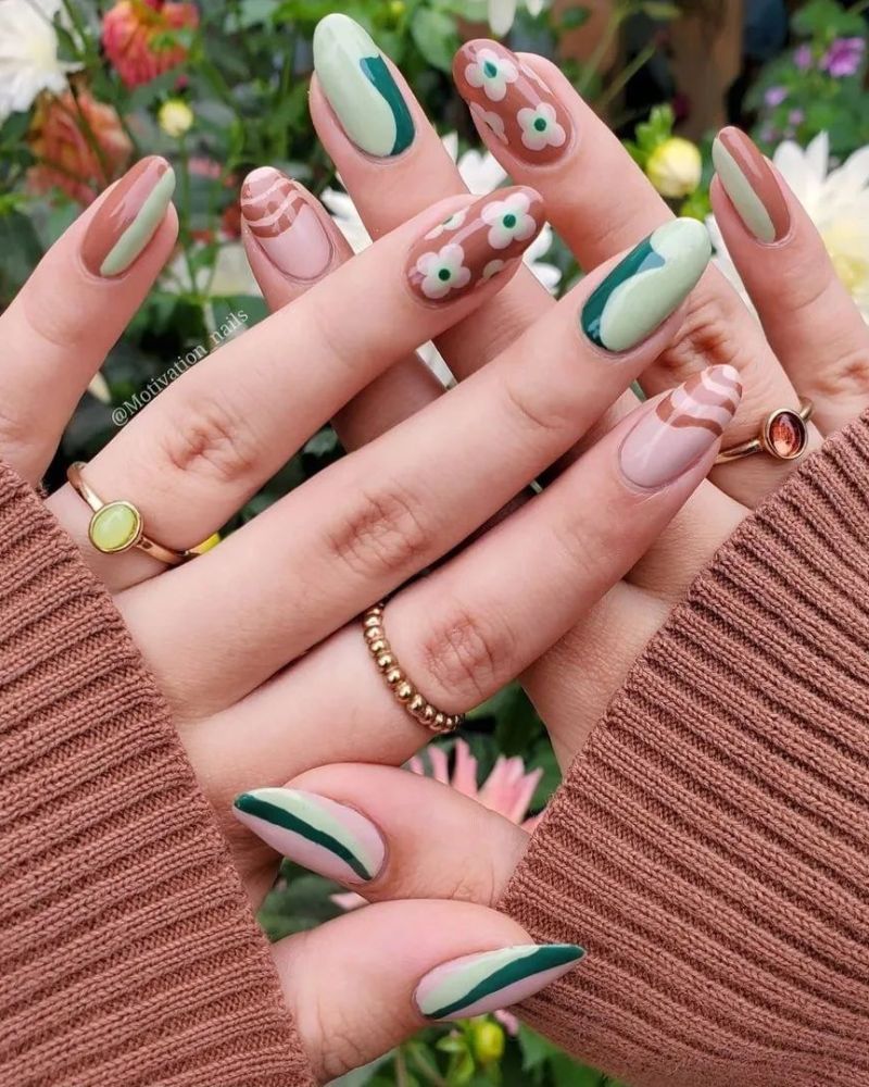 fall season nails with cute nail art in green and brown shades, on almond shape