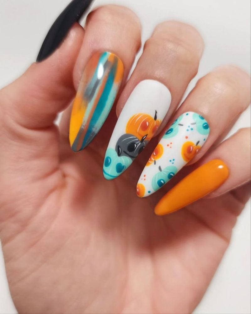 stiletto fall nails for Halloween with pumpkin nail art, orange, balck and blue nail polish