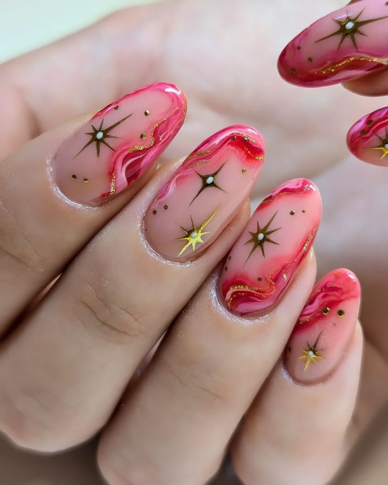 hot pink nails with a design, gold stars nail art