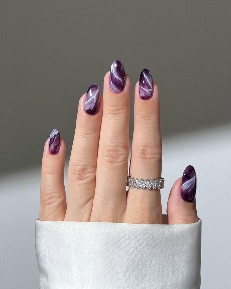 marble nail design with plum nail color