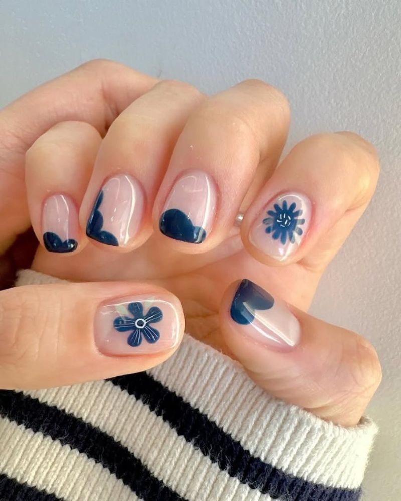 short square nails with natural base and navy blue nail art