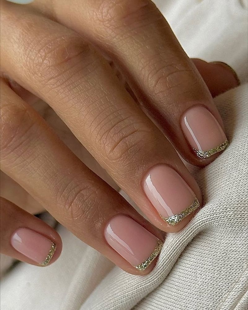 square nail french mnanicure with sparkly gold tips