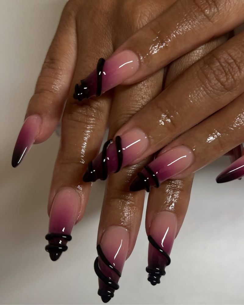 long stiletto nails with ombre purple at the tips and 3d nail art
