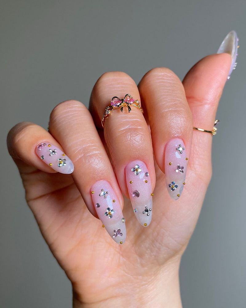 long almond nails with gemstone nail art