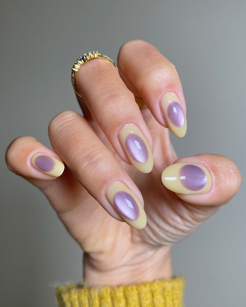 pastel yellow spring nail art with lavender cat eye