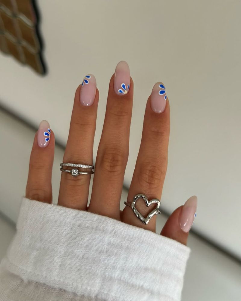 simple nude nails for summer with blue flower nail art