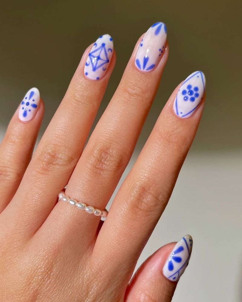 milky white nails with blue nail art for summer manicure