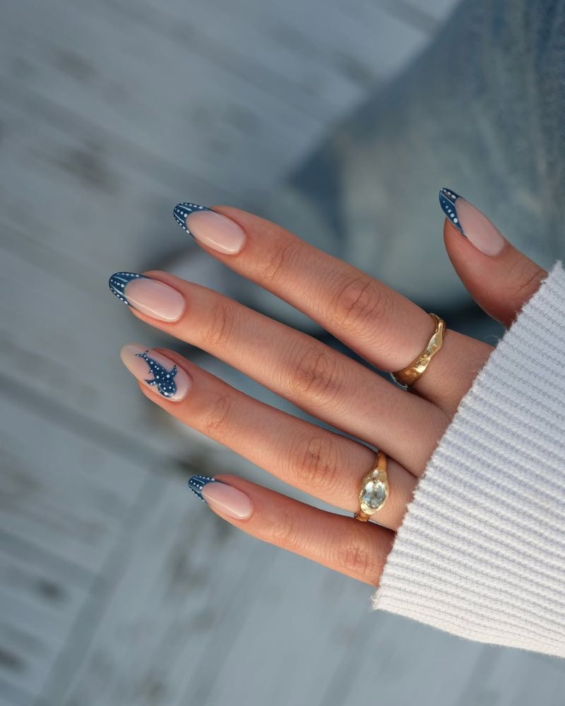 navy blue french tip nails with white polka dots and painted whale shark on the accent nail