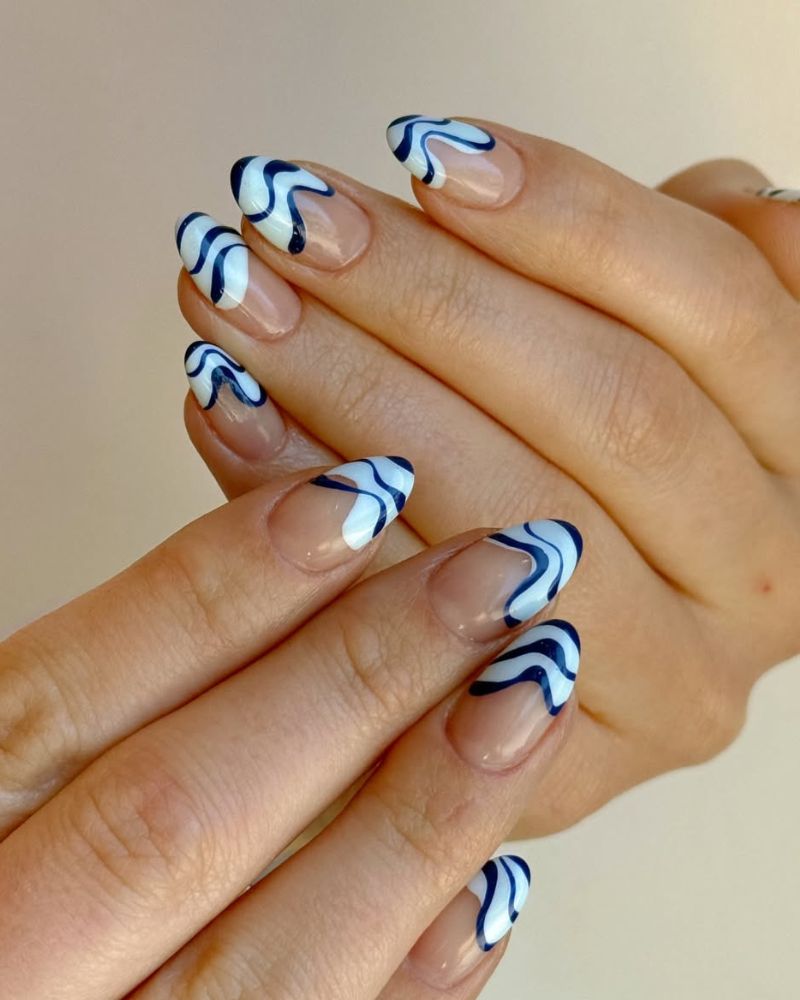 simple nails for summer with wavy blue tips that look like the sea waves