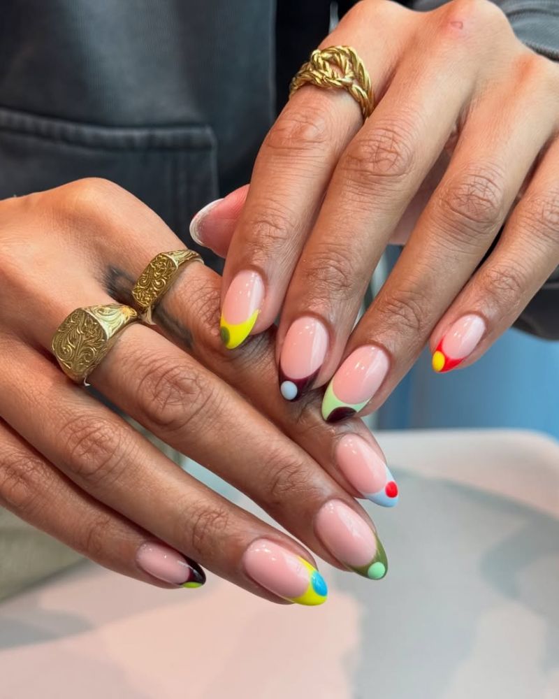 abstract multicolor french tip nail art with color pops at the corners and tips on short oval nails