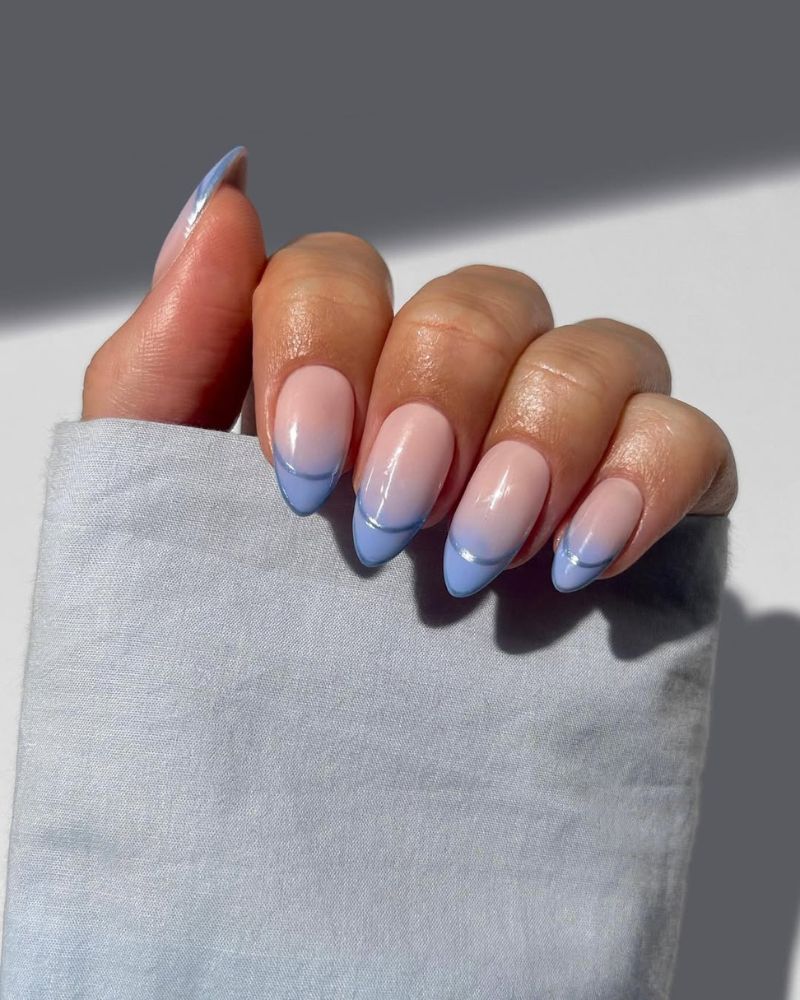 summer french tip nails in cornflower blue ombre with thin chrome edge on almond nails