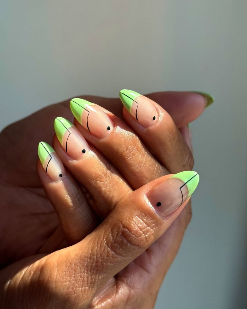 neon lime green french tips with thin angular black line art and single dot accent on almond nails