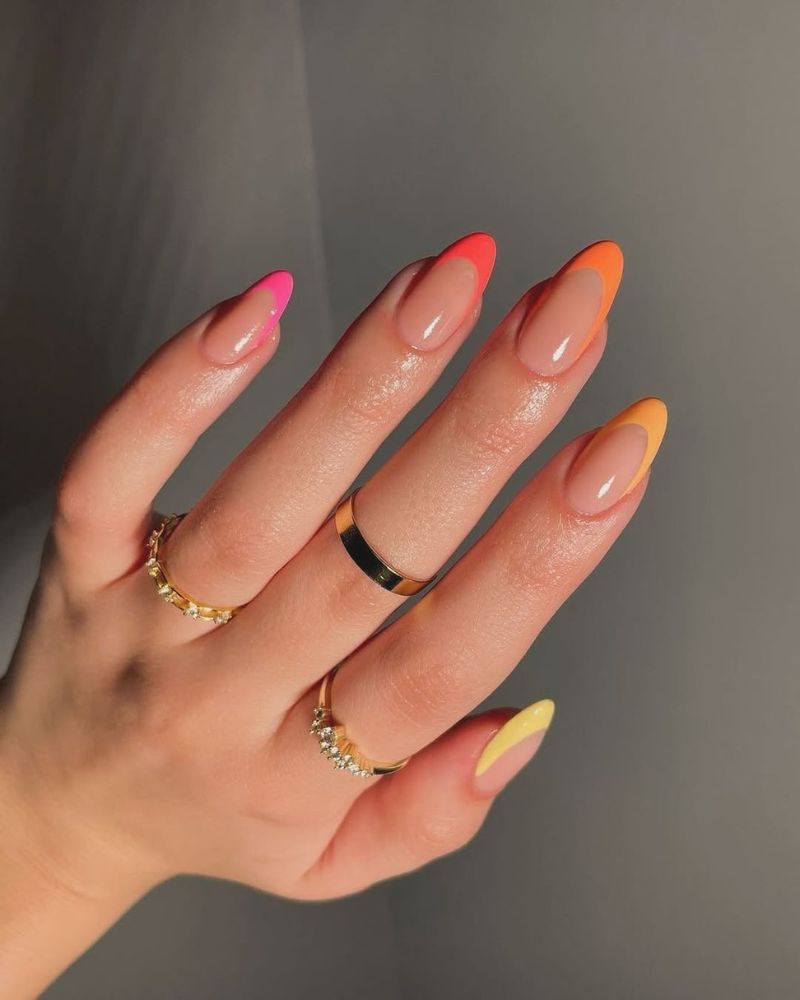 cute summer french nails with neon sunset tips each nail a different warm shade on almond nails