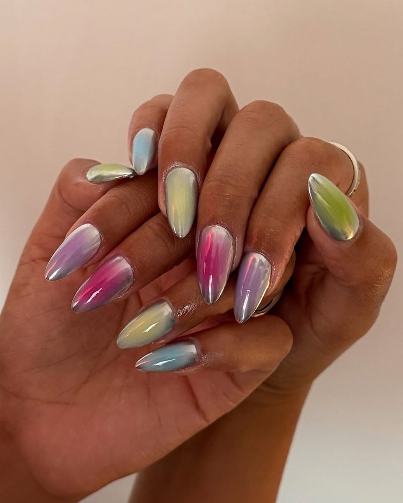 metallic silver nails with colorful aura nail art on a long almond shape
