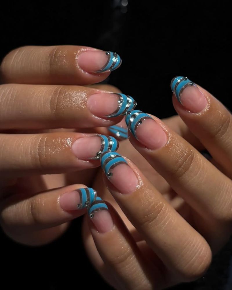 nude nails with blue french tip manicure and silver stripes