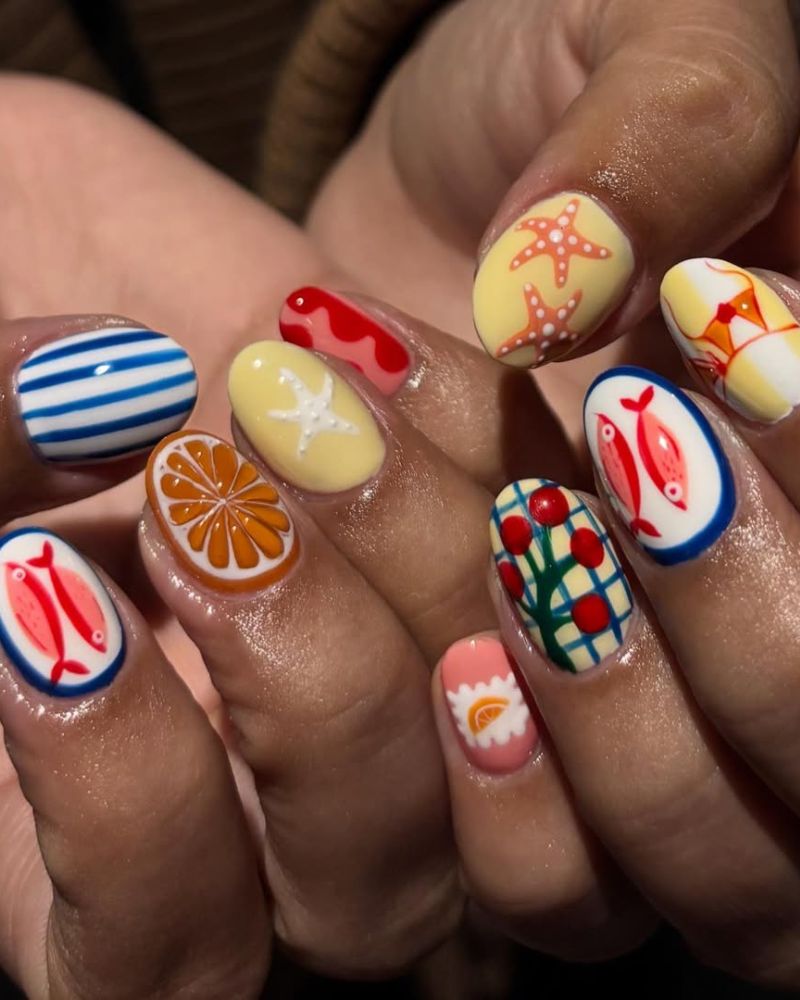summertime nails designs with Mediterranean-inspired art including fish, Sicilian tiles, and orange slice
