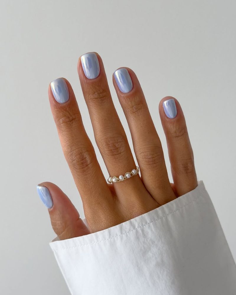 short square nails in periwinkle pearl chrome with a soft blue shimmer
