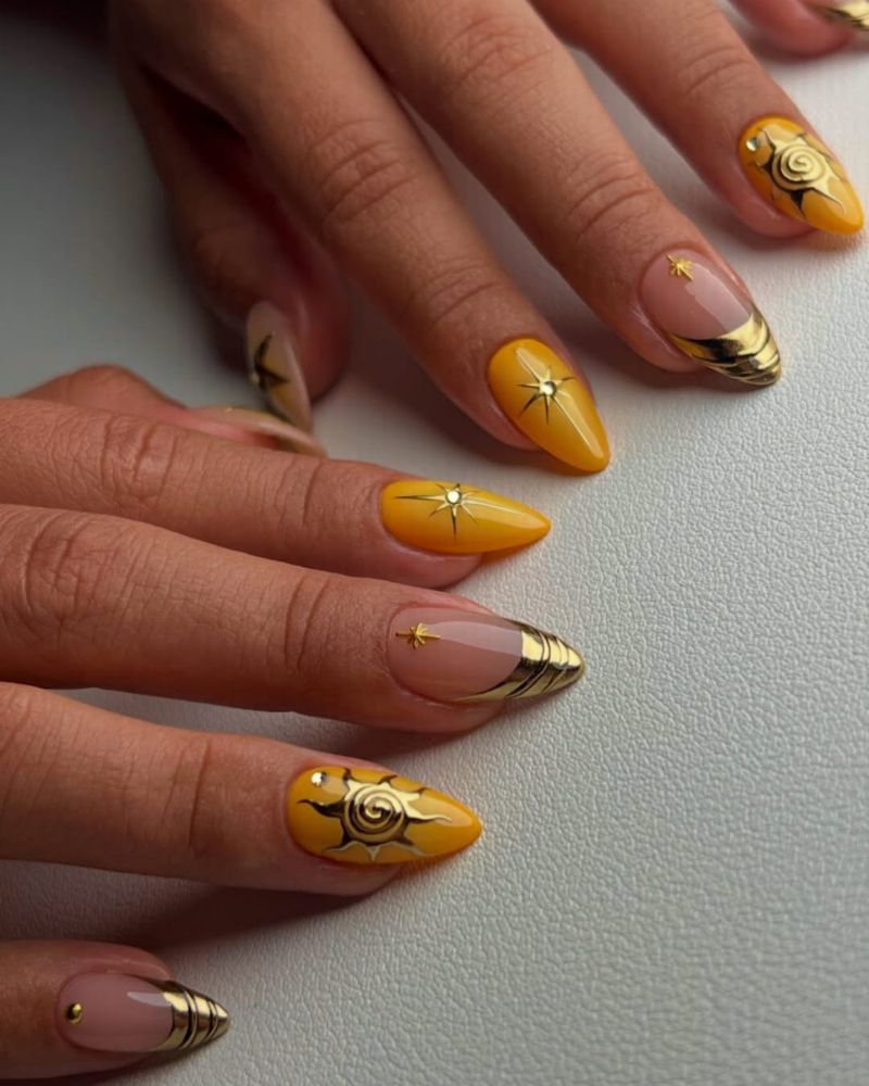 summertime nail designs with amber yellow base and painted gold sun spiral art
