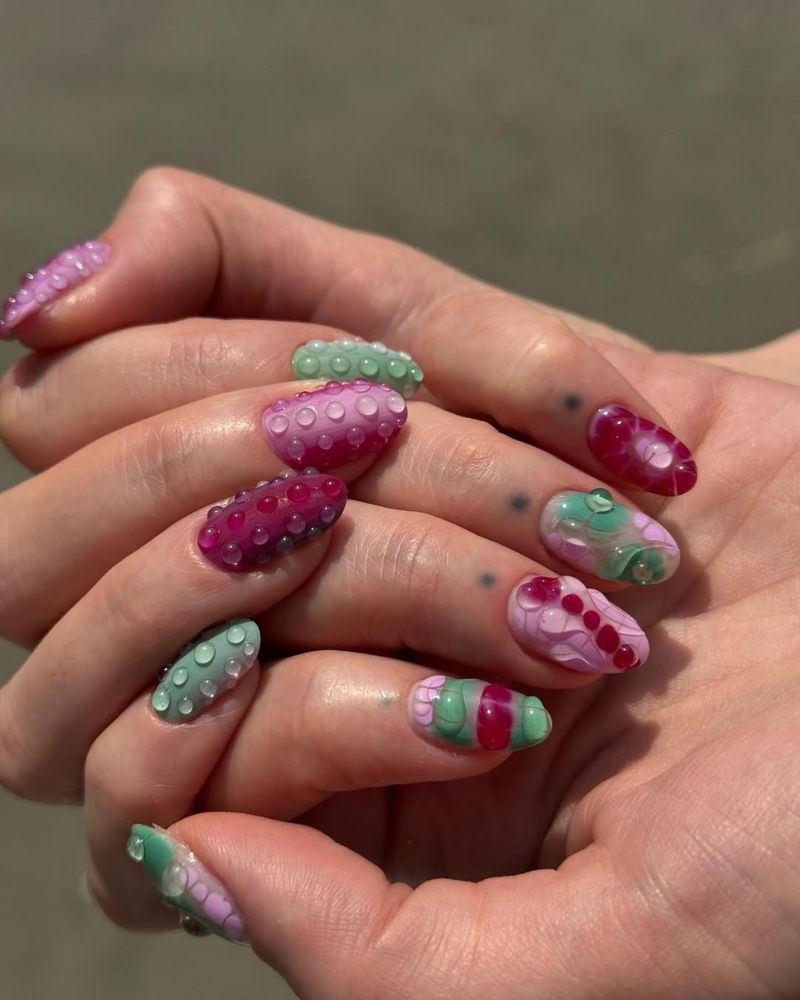 3D bubble gel nails in mauve, hot pink, and mint with swirling watercolor bases
