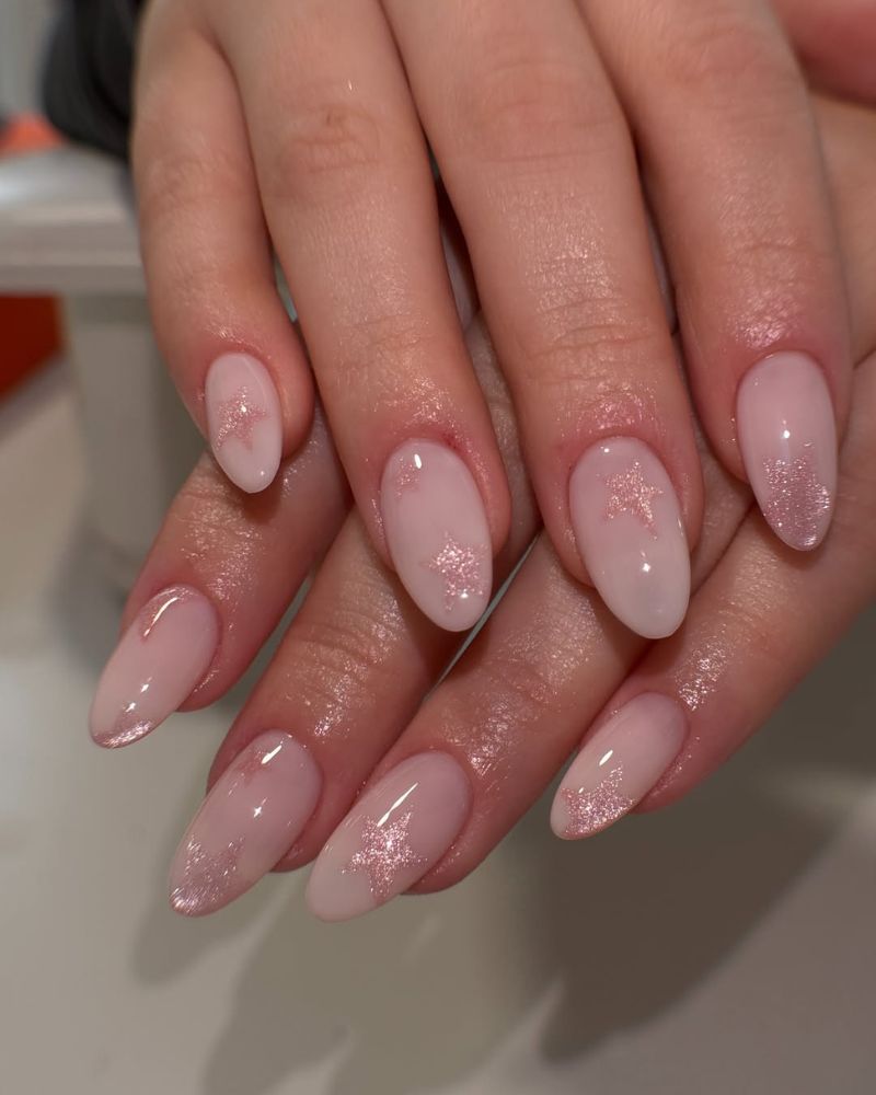 simple milky pink nails with cat eye stars nail art