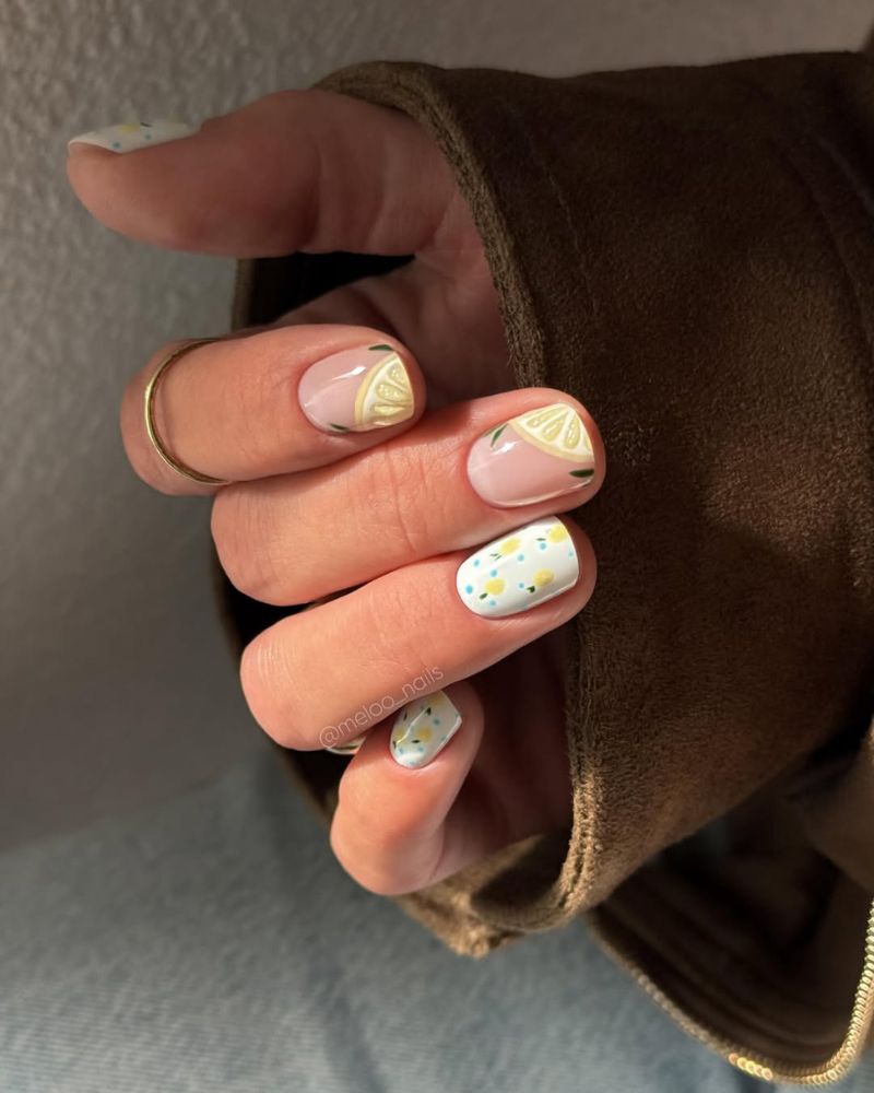 short nails with lemon slice French corner art and a mini lemon accent nail
