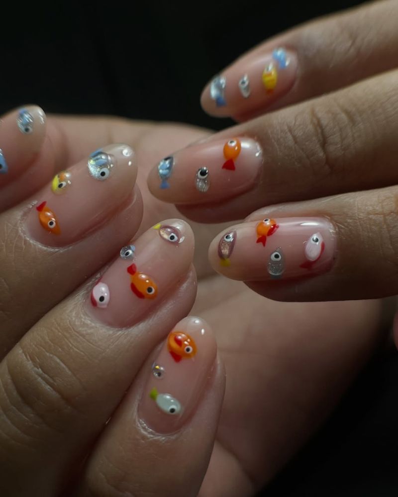 simple nude nails with colorful fishes nail art