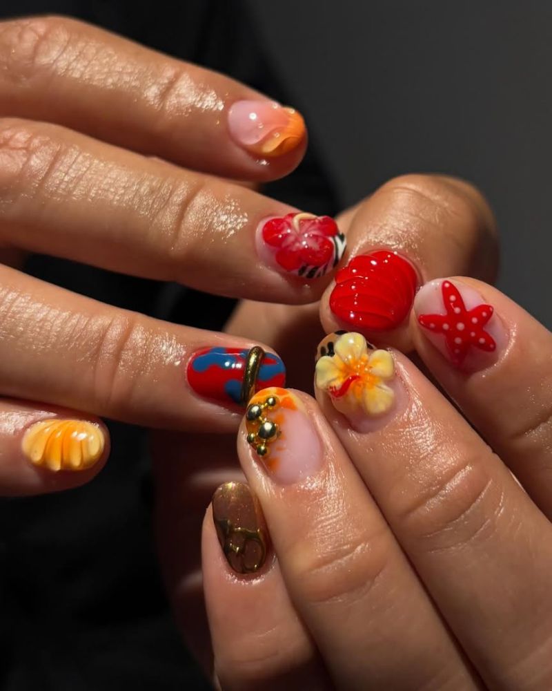 short oval nails with 3D tropical elements including hibiscus and starfish

