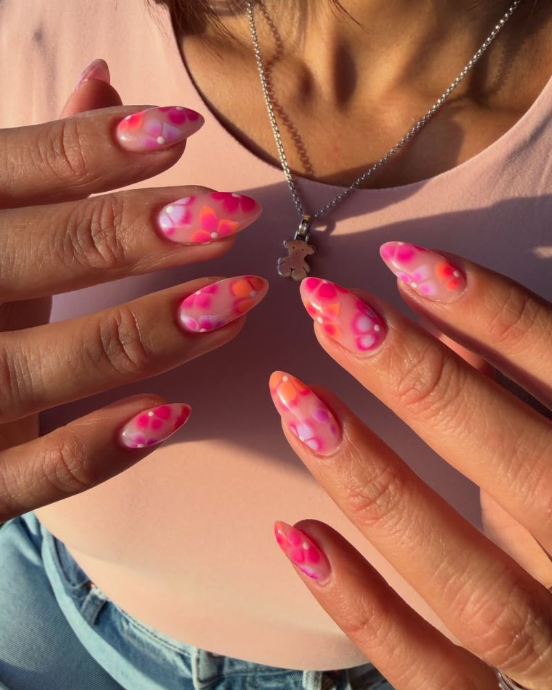 long almond nails with hot pink and orange watercolor aura bloom nail art
