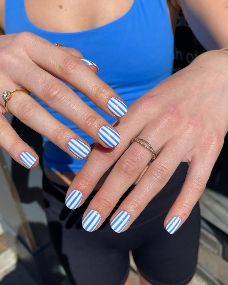 white nails with blue stripes nail art