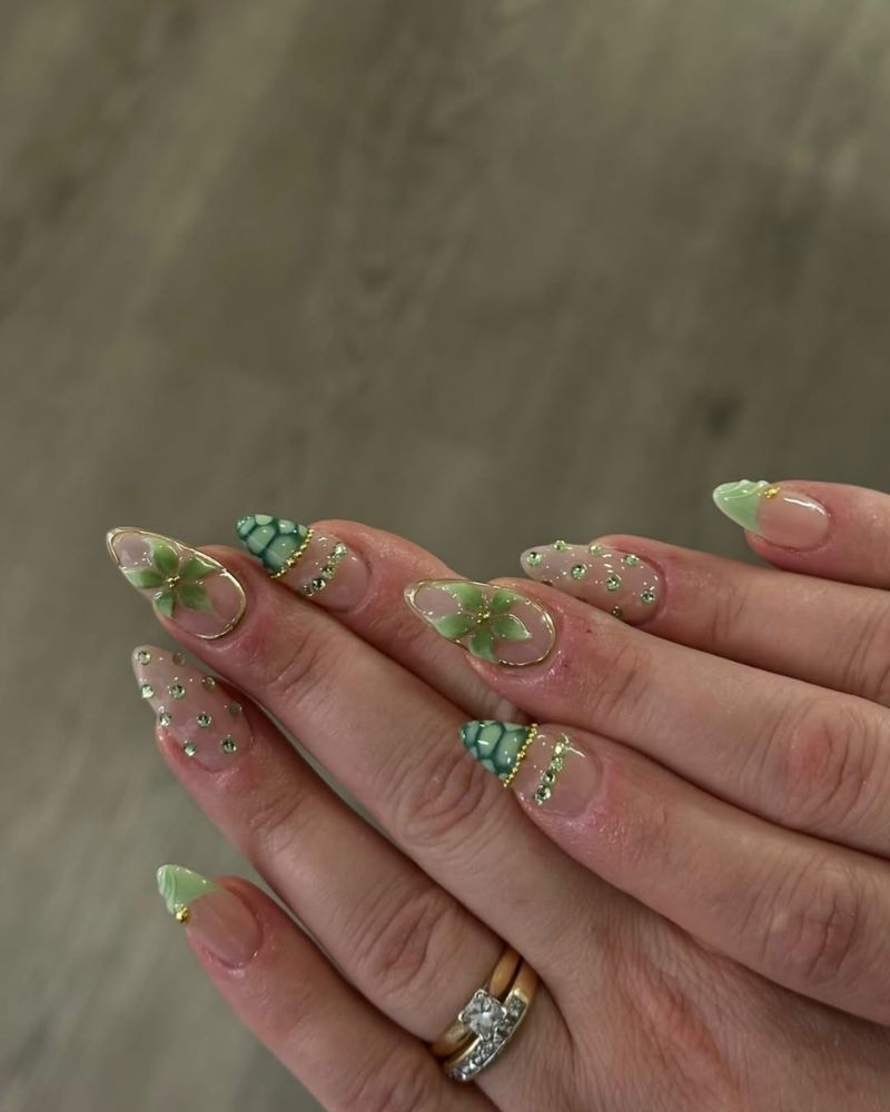 sheer almond nails with 3D green flowers teal butterfly mosaic tip and scattered crystals