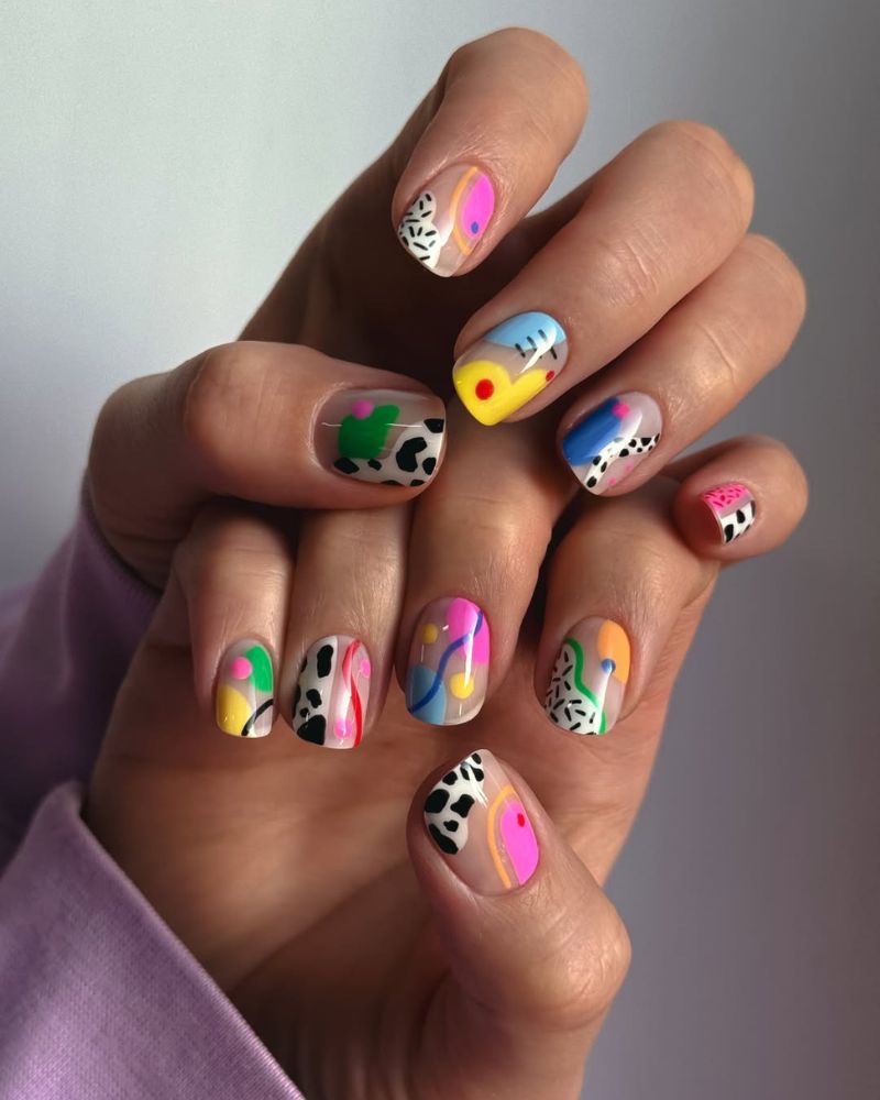 bold summer nail art on short square nails with cow print cactus and neon abstract shapes
