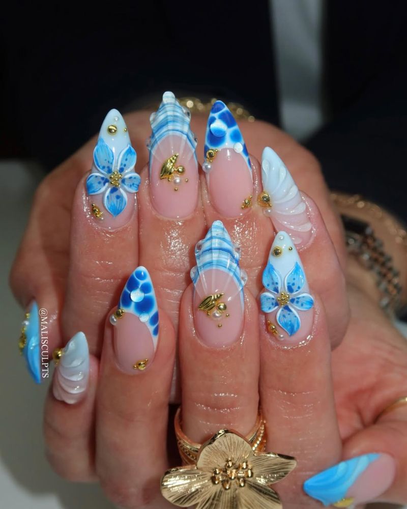 ocean nail art with 3D blue flowers sculpted shell swirls and pearl and gold accents