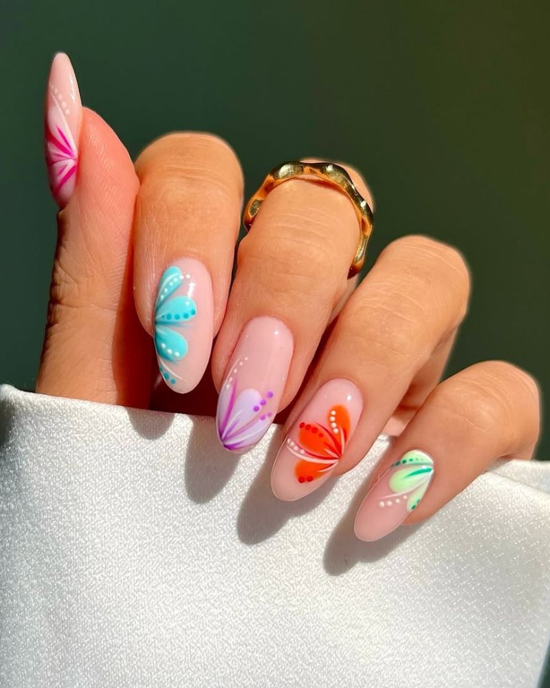 sheer nude nails with individual wildflowers in teal purple orange and lime green