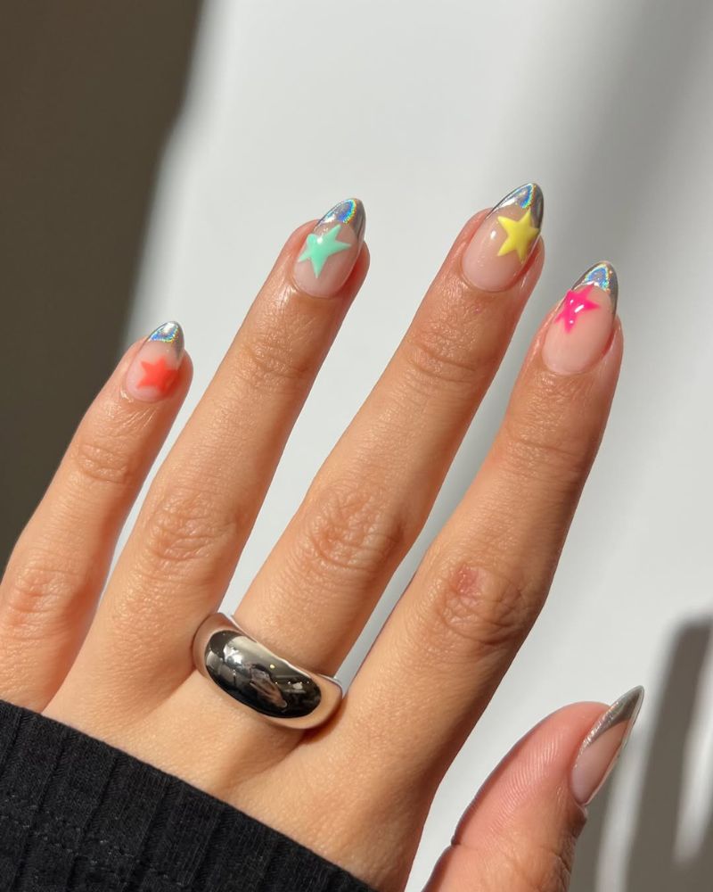 chrome french tip nails with neon star accents in mint yellow and hot pink