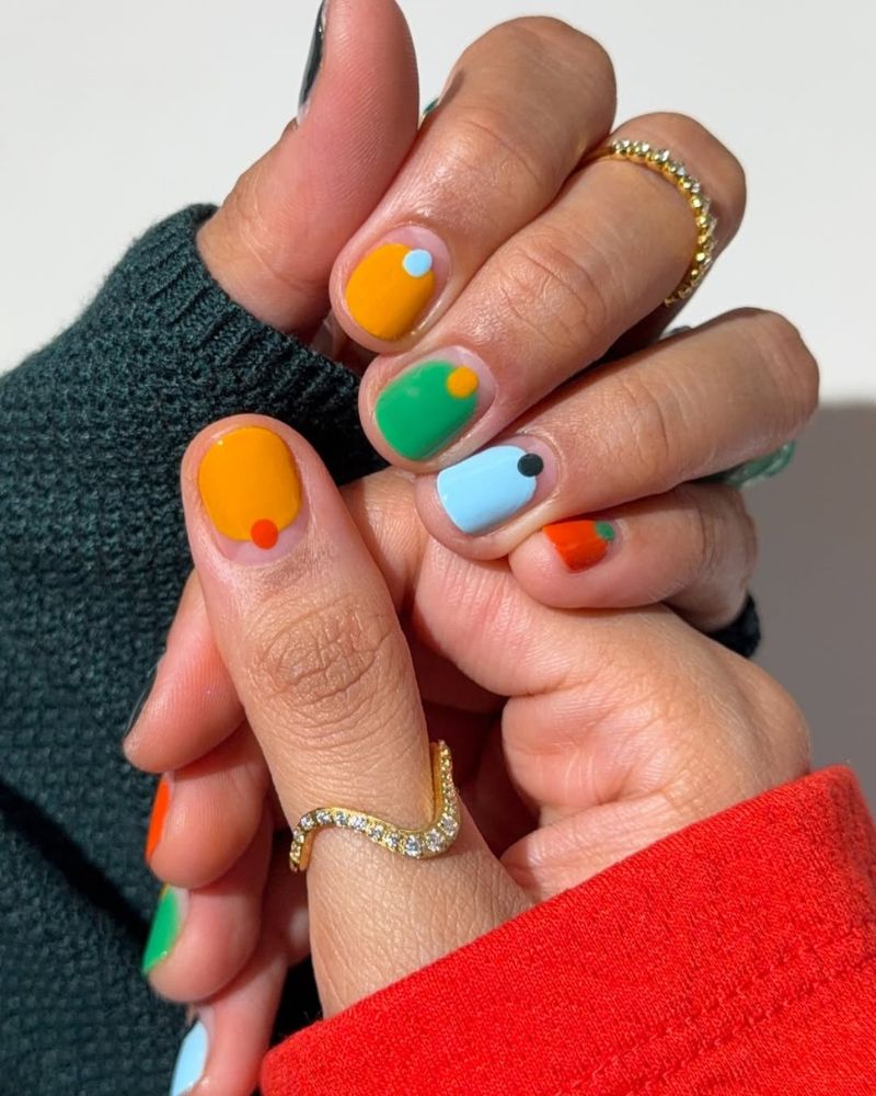 short square nails with bold abstract color block in orange green and sky blue