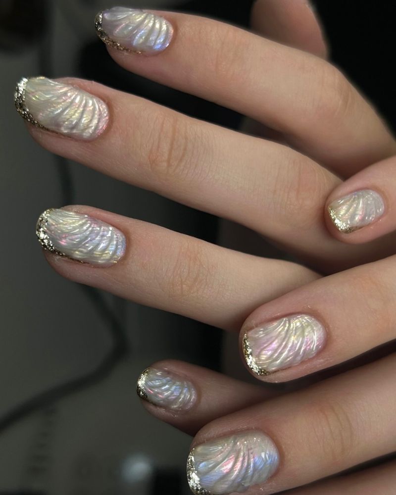 sculpted iridescent shell texture nails with gold glitter tip edge