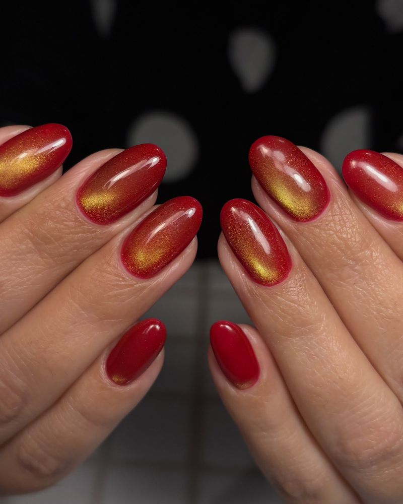 deep red almond nails with copper gold cat eye shimmer rust effect