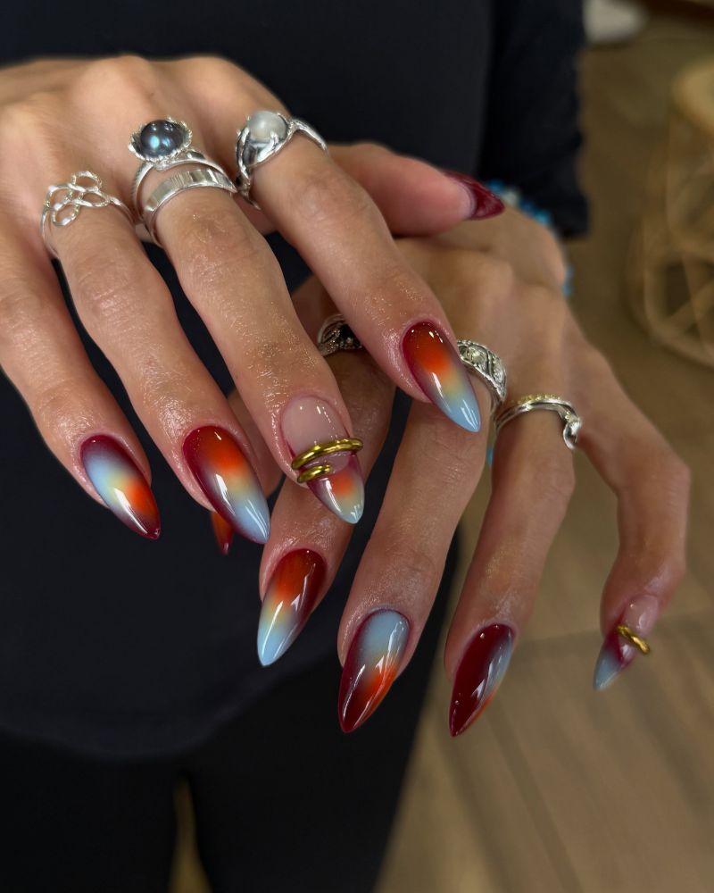 editorial aura set stiletto nails with red orange icy blue gradient multiple silver rings