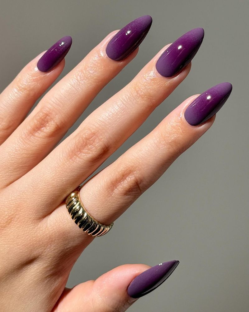deep eggplant purple long almond nails with glossy satin mix gold ribbed ring