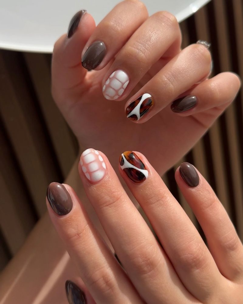 short oval chocolate brown nails in dark mocha with white croc texture accent nail and warm amber tortoiseshell accent both hands