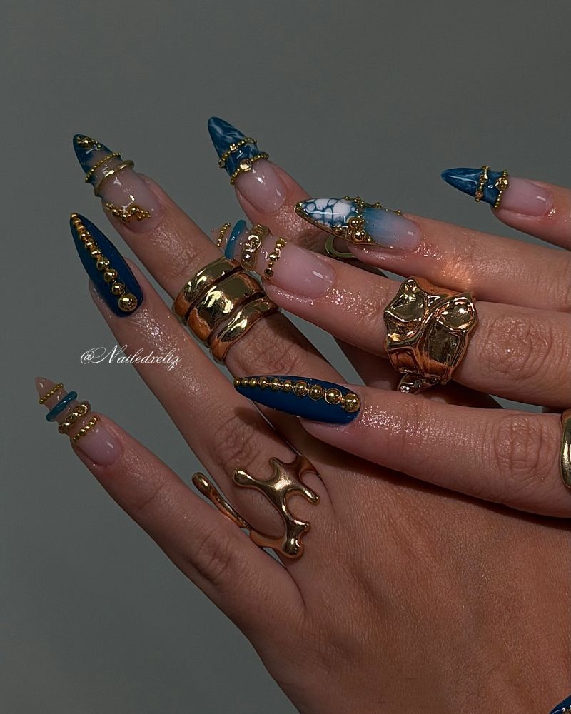 midnight blue editorial stiletto set with gold bead accents and marble texture