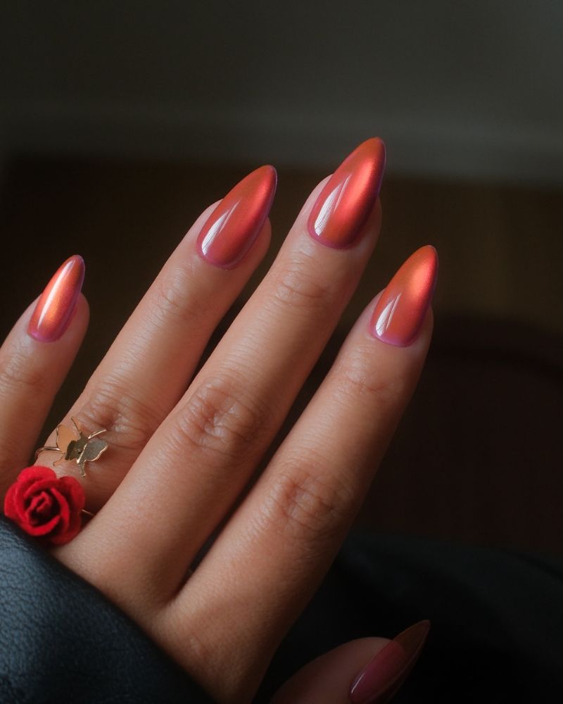 warm copper bronze orange cat eye long almond nails with butterfly ring