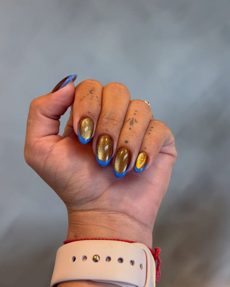 gold amber cat eye on cobalt blue short round nails