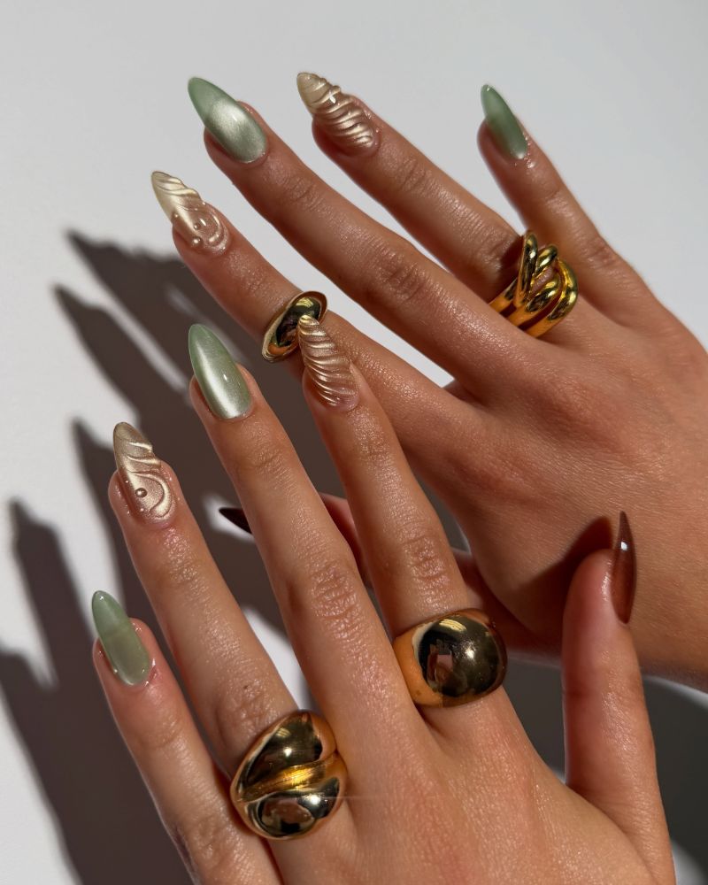 sage green cat eye almond nails alternating with textured gold sculptural nails