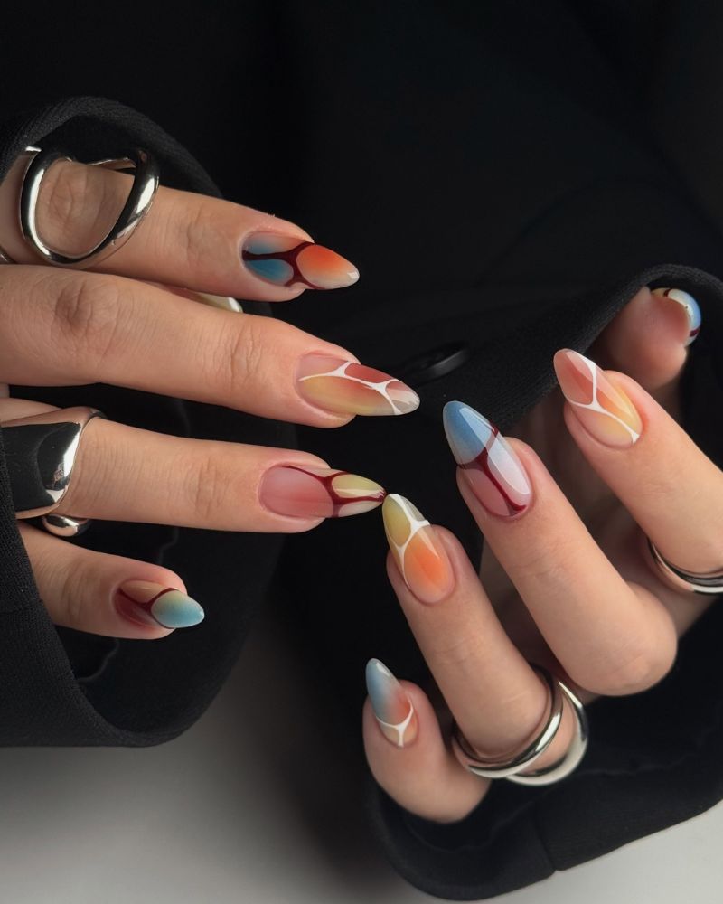 editorial multi-color watercolor aura long almond nails with dark red and white outline details